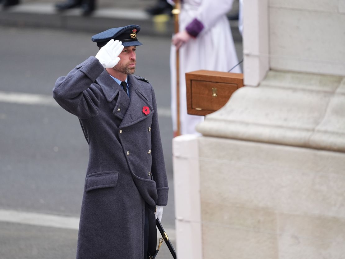 Several royals opted for to wear military dress for the poignant occasion. Prince William, wearing a greatcoat over his Royal Air Force uniform in the rank of Wing Commander, salutes after laying his wreath. 