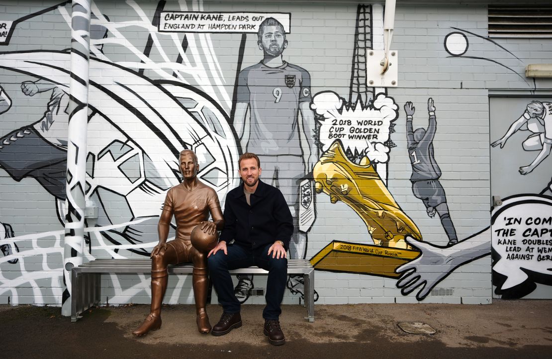 Harry Kane next to his statue at the unveiling on Monday.