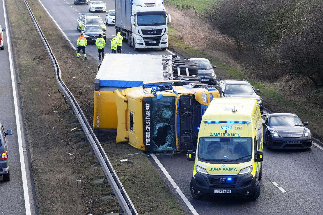 An ambulance attends the scene of a crash during strong winds in Durham county.