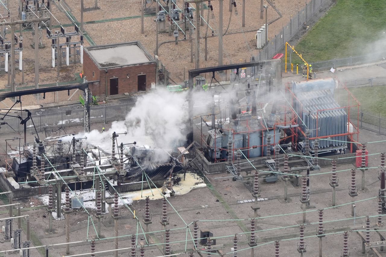 Smoke rises from the North Hyde electrical substation, which caught fire overnight, in London on Friday.