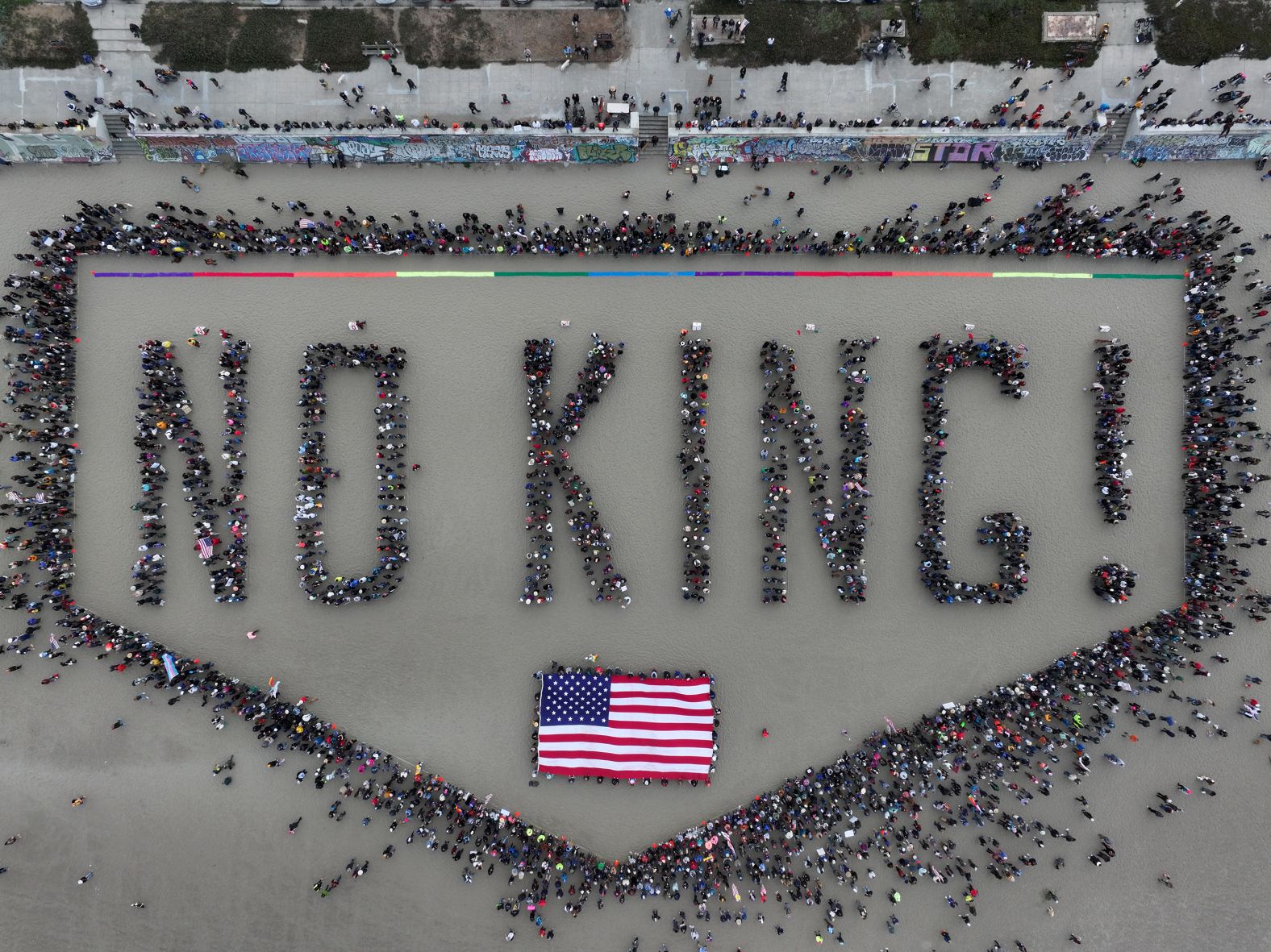 Protesters spell out “No King!” at San Francisco’s Ocean Beach on Saturday, June 14. <a href="index.php?page=&url=https%3A%2F%2Fwww.cnn.com%2F2025%2F06%2F14%2Fus%2Fgallery%2Fno-kings-protests">More than 2,000 protests took place across all 50 states</a> through the No Kings movement, which organizers say seeks to reject “authoritarianism, billionaire-first politics, and the militarization of our democracy.” <a href="index.php?page=&url=https%3A%2F%2Fwww.cnn.com%2F2025%2F06%2F13%2Fus%2Fmilitary-parade-protests-trump">The mobilization</a> was a direct response to Saturday's <a href="index.php?page=&url=https%3A%2F%2Fwww.cnn.com%2F2025%2F06%2F14%2Fpolitics%2Fgallery%2Ftrump-parade-military-photos">military parade</a> in Washington, DC, that celebrated the 250th anniversary of the US Army and coincided with President Donald Trump’s 79th birthday.