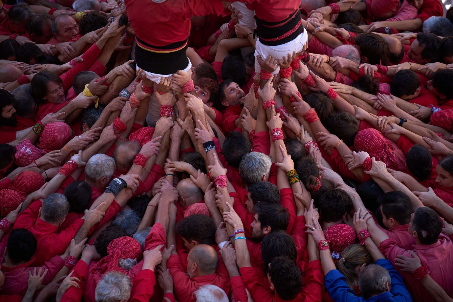 People build a human tower, also known as a “castell,” during La Mercè celebrations in Barcelona, Spain, on Wednesday, September 24.