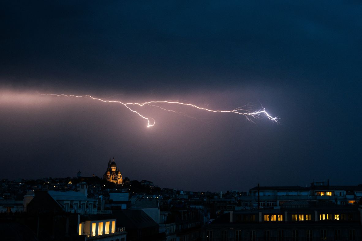 A lightning bolt lights up the sky over the Sacré-Cœur Basilica in Paris on Wednesday, June 25.