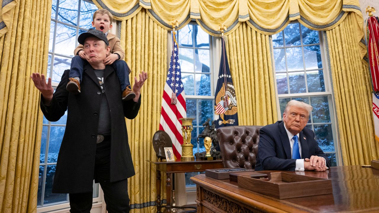 TOPSHOT - Tesla and SpaceX CEO Elon Musk with his son X Æ A-Xii join US President Donald Trump as he signs executive orders in the Oval Office of the White House in Washington, DC, February 11, 2025. Tech billionaire Elon Musk, who has been tapped by President Donald Trump to lead federal cost-cutting efforts, said the United States would go 