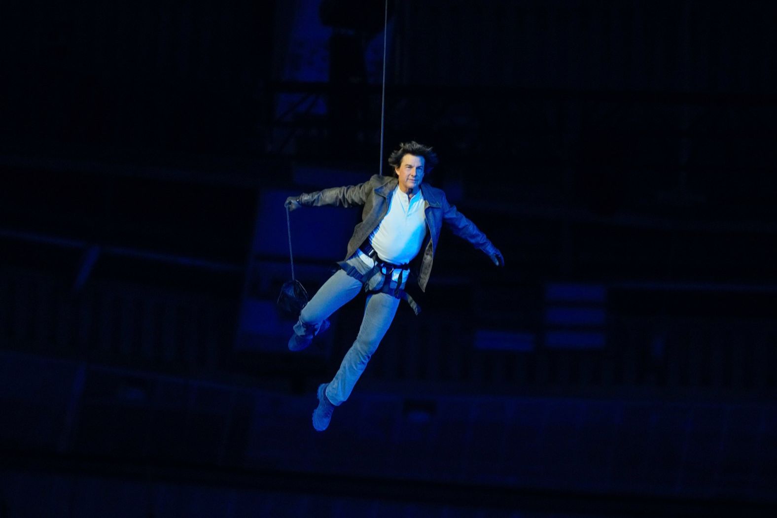 Actor Tom Cruise is lowered onto the floor of the Stade de France after jumping off the stadium's roof during the <a >Olympic closing ceremony</a> on Sunday, August 11. He took the Olympic flag from Los Angeles Mayor Karen Bass and rode off on a motorcycle. Los Angeles will be the next city to host the Summer Games.