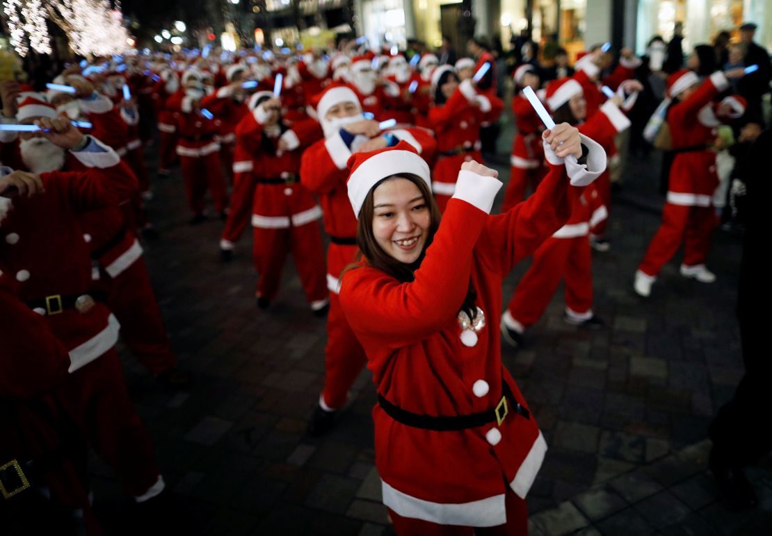 Workers dressed as Santa Claus parade through Tokyo's Marunouchi business district.