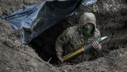 A Ukrainian serviceman of the First Presidential Brigade Bureviy (Hurricane) of the National Guard of Ukraine holds an artillery shell as he prepares to fire a howitzer towards Russian troops at a position in a frontline, amid Russia's attack on Ukraine, near the town of Kreminna, Ukraine March 4, 2024. REUTERS/Inna Varenytsia