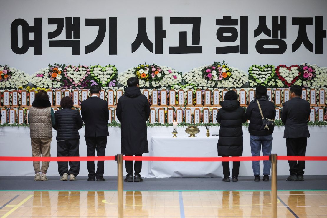 Mourners stand at a memorial altar for victims of the Jeju Air crash at Muan International Airport, at Muan sport park in Muan, South Korea, December 30, 2024.