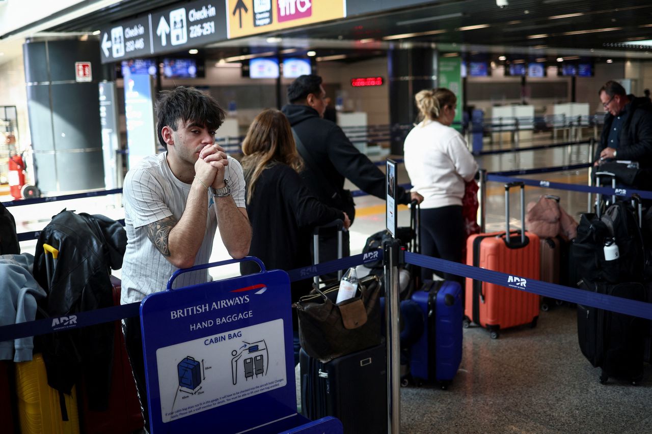 Nicolas Di Francescantonio waits for informations about his flight to Heathrow Airport, from Fiumicino Airport near Rome.