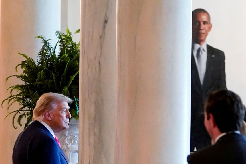 President Donald Trump looks on, as the portrait of former President Barack Obama can be seen in the background, at the White House on June 26.
