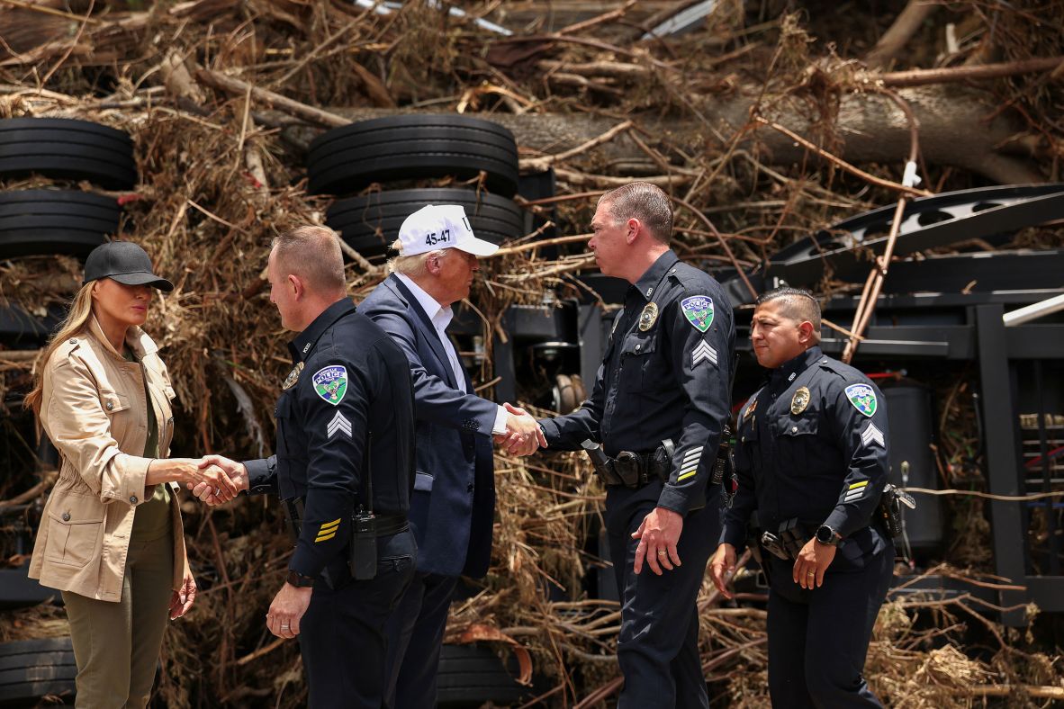 President Donald Trump and first lady Melania Trump shake hands with Kerrville police officers, as they visit the devastation along the banks of the Guadalupe River on Friday.