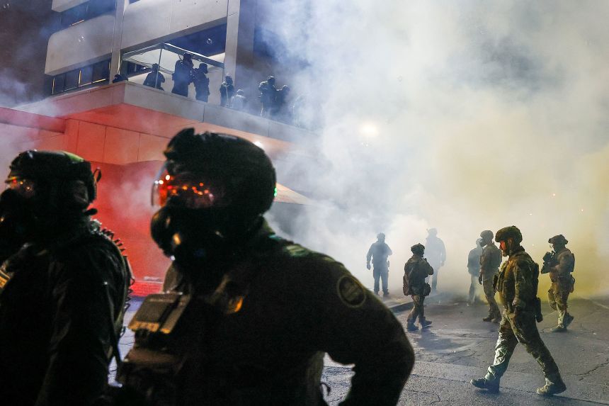 Federal agents deploy tear gas as demonstrators gather at Portland's Immigration and Customs Enforcement facility on Saturday night.