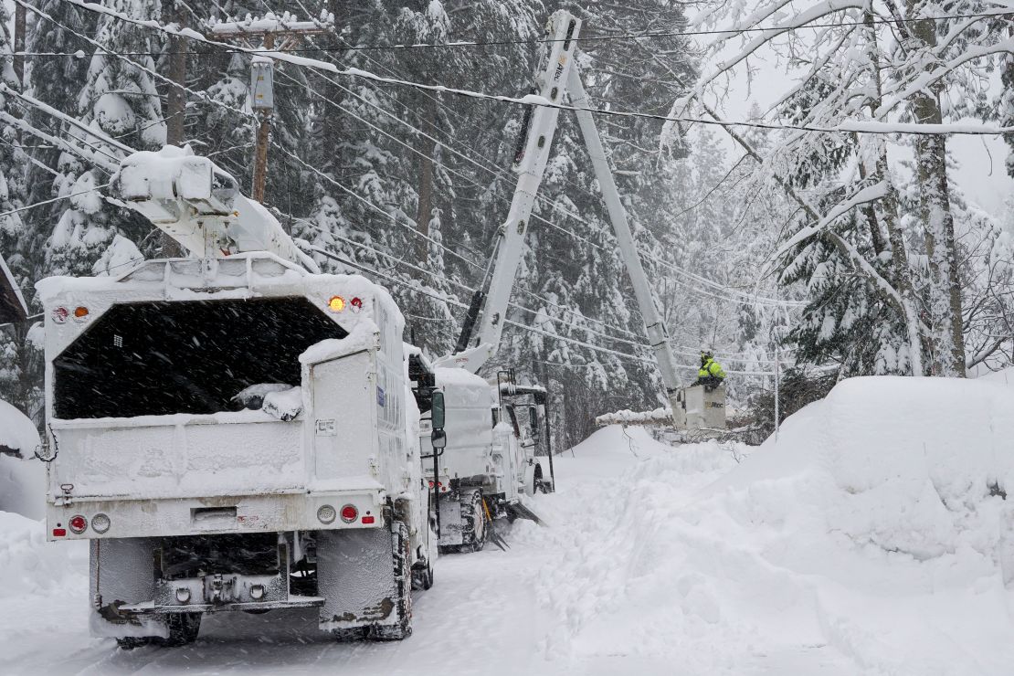 Crews clear trees along Donner Lake, where power was lost due to the storm Saturday, March 2, 2024, in Truckee, California.