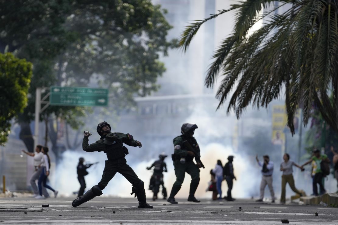 Police hurl a gas canister at protesters demonstrating against the official election results declaring President Nicolas Maduro's reelection, the day after the vote, in Caracas on July 29.