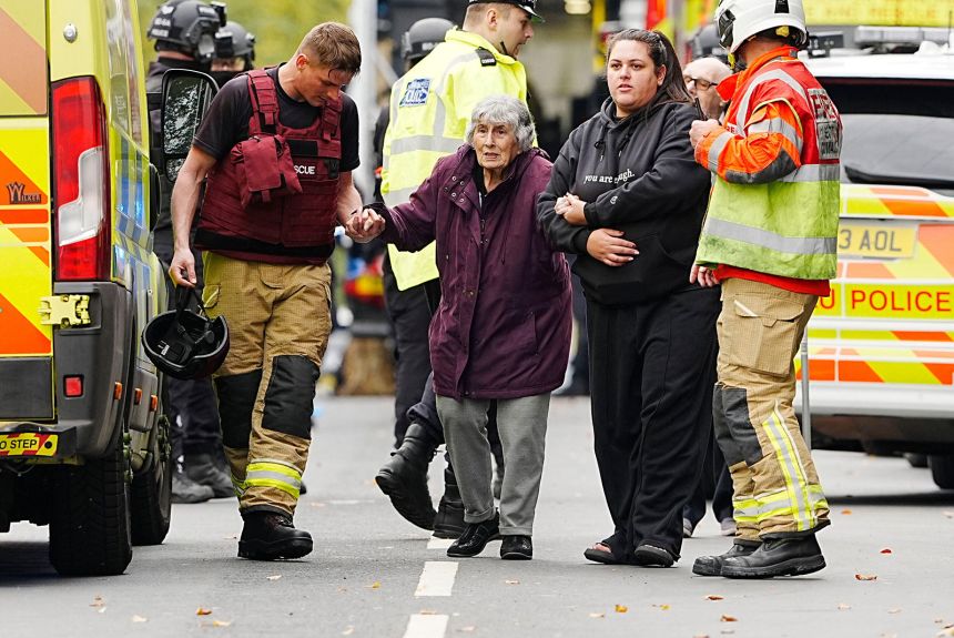 A member of the public is helped from the scene of a stabbing incident at Heaton Park Hebrew Congregation synagogue in Manchester, England, on Thursday.