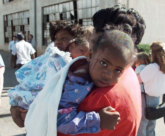 A woman comforts an injured child following the explosion.