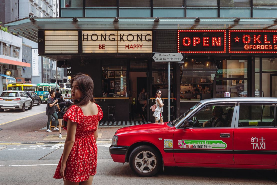 Chinese tourists pose for pictures in Hong Kong's Kennedy Town district.