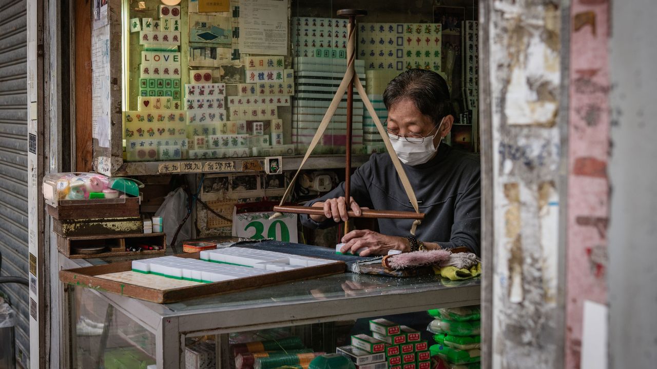 Ho Sau-Mei, 68, carvs mahjong tiles with a traditional tool at her shop in Hong Kong, China, on Wednesday, April 30, 2025.