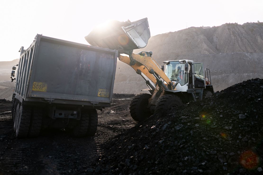 A loader fills a dump truck at the coal mine, operated by South Eastern Coalfields, in Chhattisgarh.