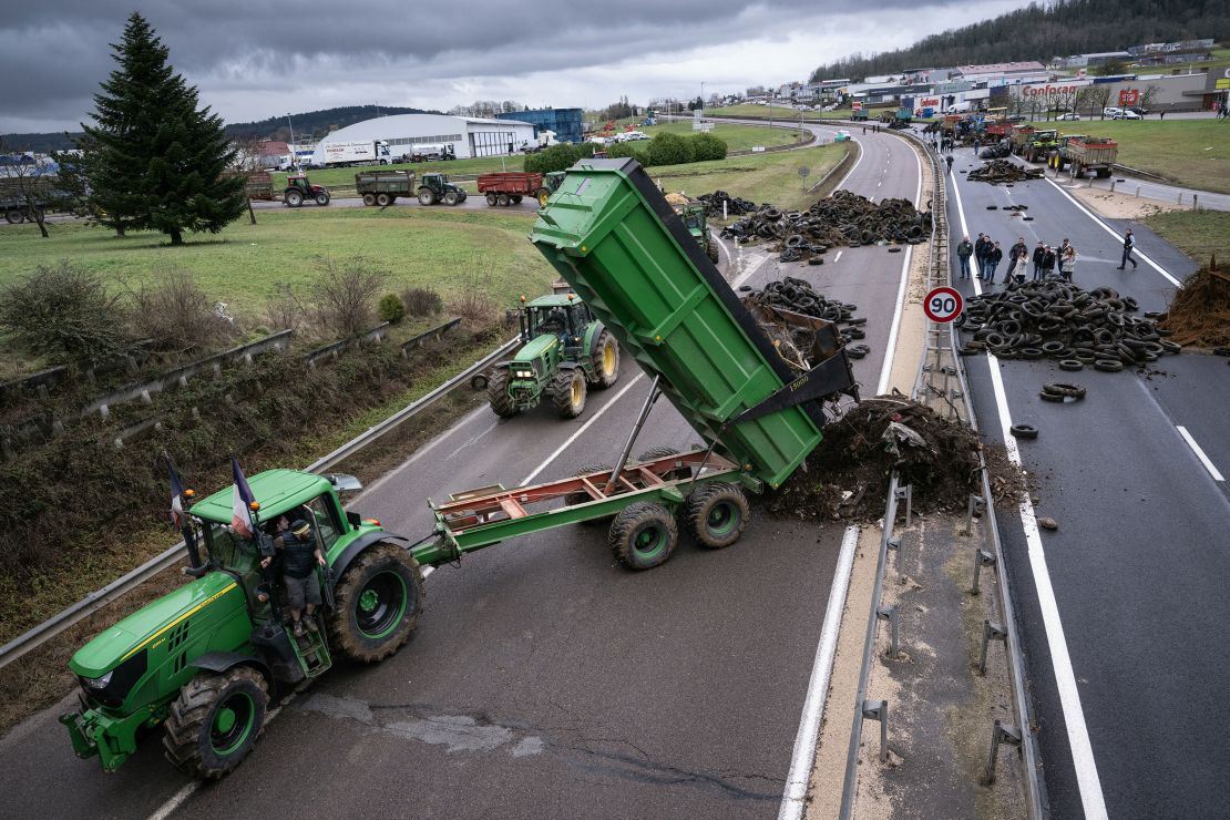 A farmer pulls waste to block a highway near Vesoul, eastern France.