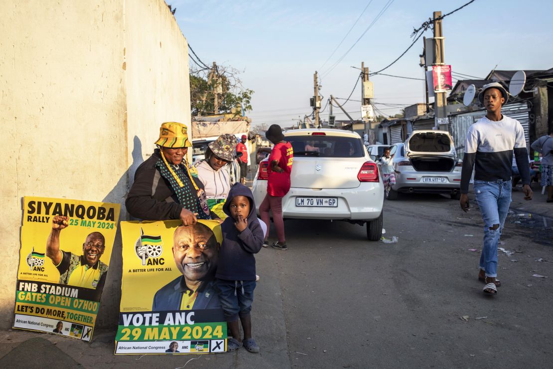 Workers for political parties including the African National Congress (ANC) and Economic Freedom Fighters (EFF) stand next to a voting station on May 27 in Alexandra Township, South Africa.
