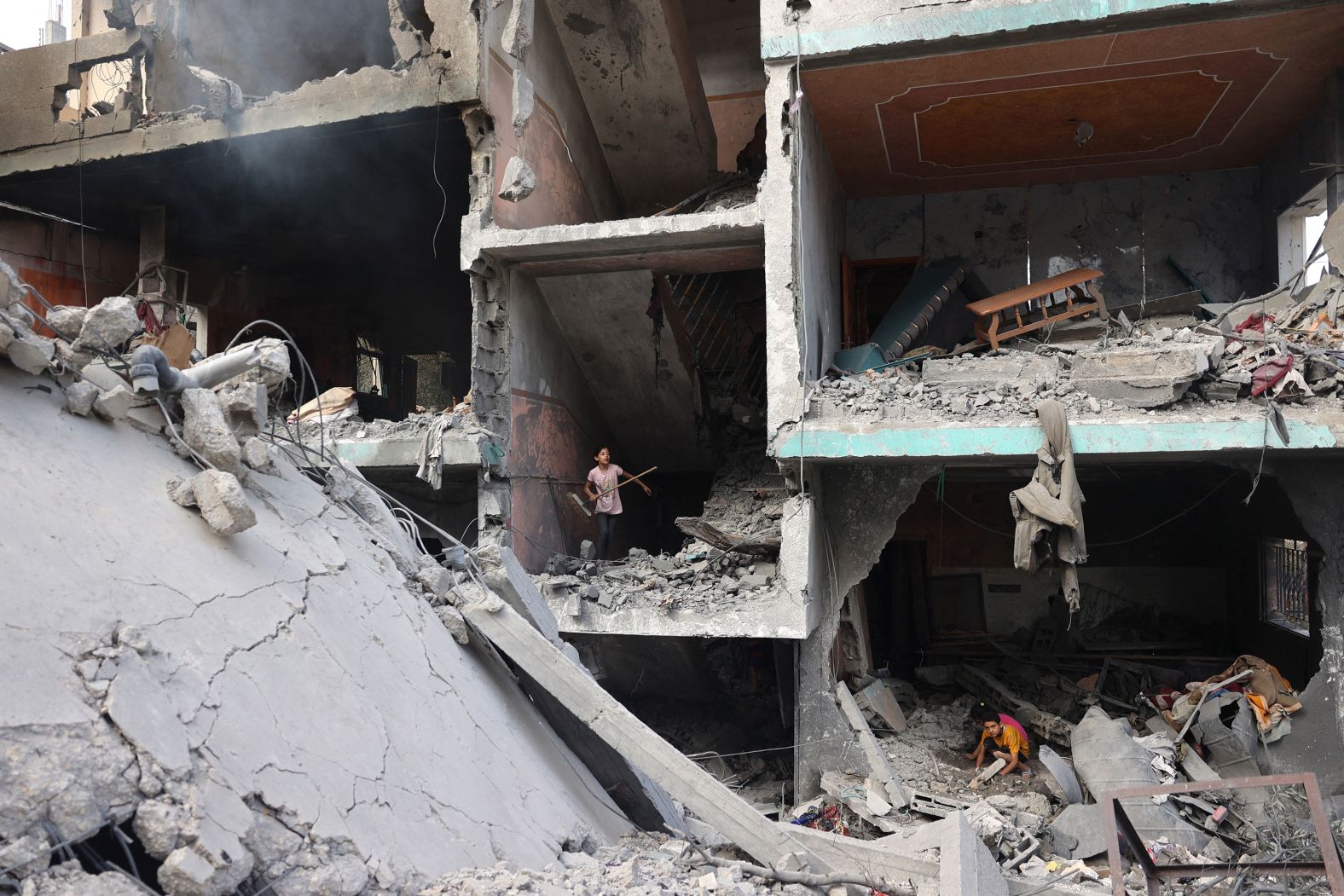 Palestinian children search through the rubble of their homes in the Nuseirat refugee camp in central Gaza on Sunday, June 9. A day earlier, the Israel Defense Forces carried out a <a href="https://www.cnn.com/2024/06/10/middleeast/inside-israels-hostage-rescue-intl-dst/index.html">daytime operation</a> that rescued four hostages being held by Hamas. More than 270 Palestinians were killed in the operation, according to Gaza health officials.