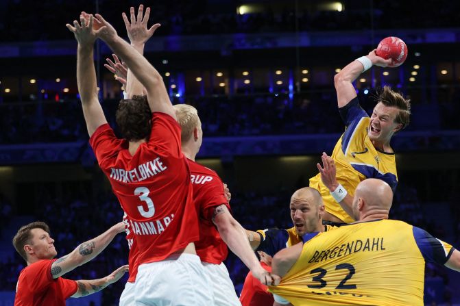 Sweden's Jonathan Carlsbog?rd jumps to shoot during a handball quarterfinal against Denmark on August 7.