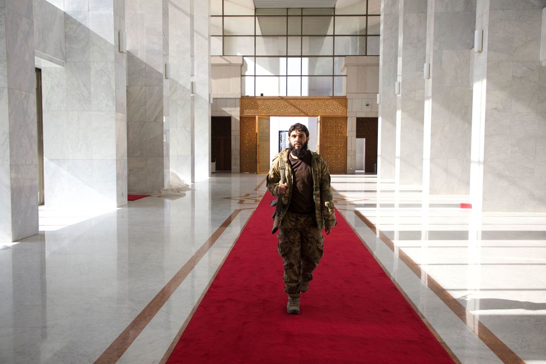 An armed man walks through the Presidential Palace in Damascus, Syria, on December 10, 2024.