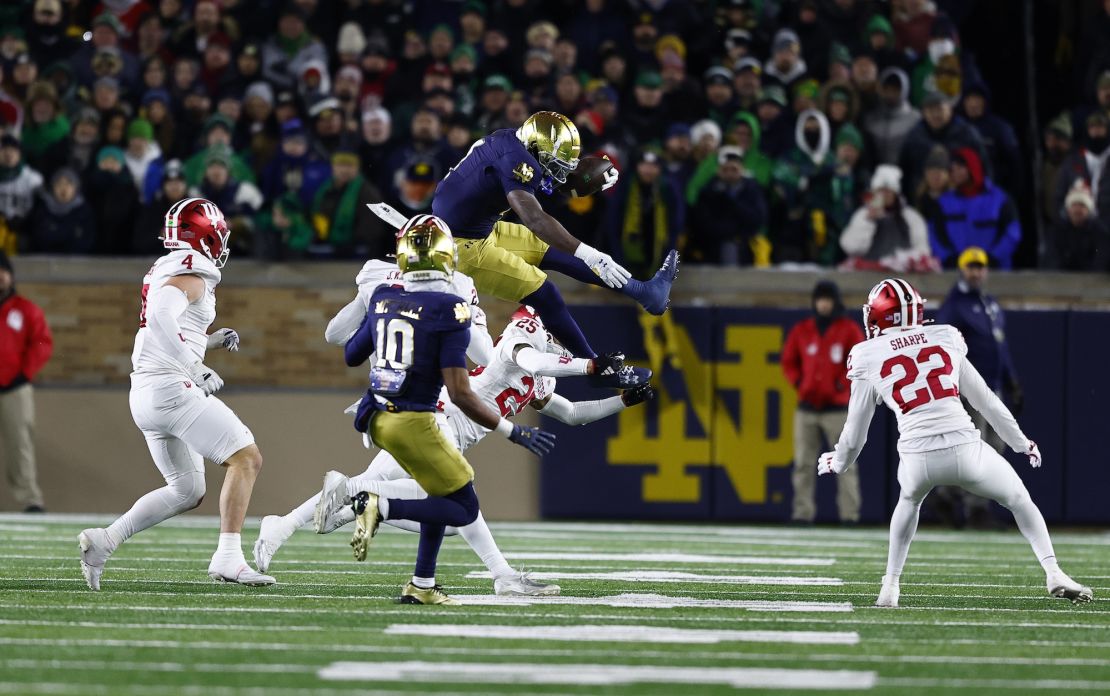 Notre Dame running back Jeremiah Love jumps over Indiana Hoosiers defensive back Amare Ferrell.