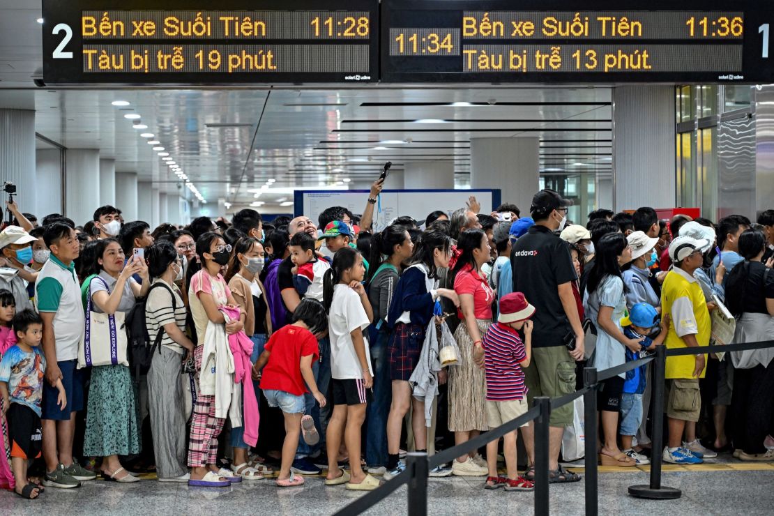 People line up as they arrive at a metro station in Ho Chi Minh City on December 22, 2024.