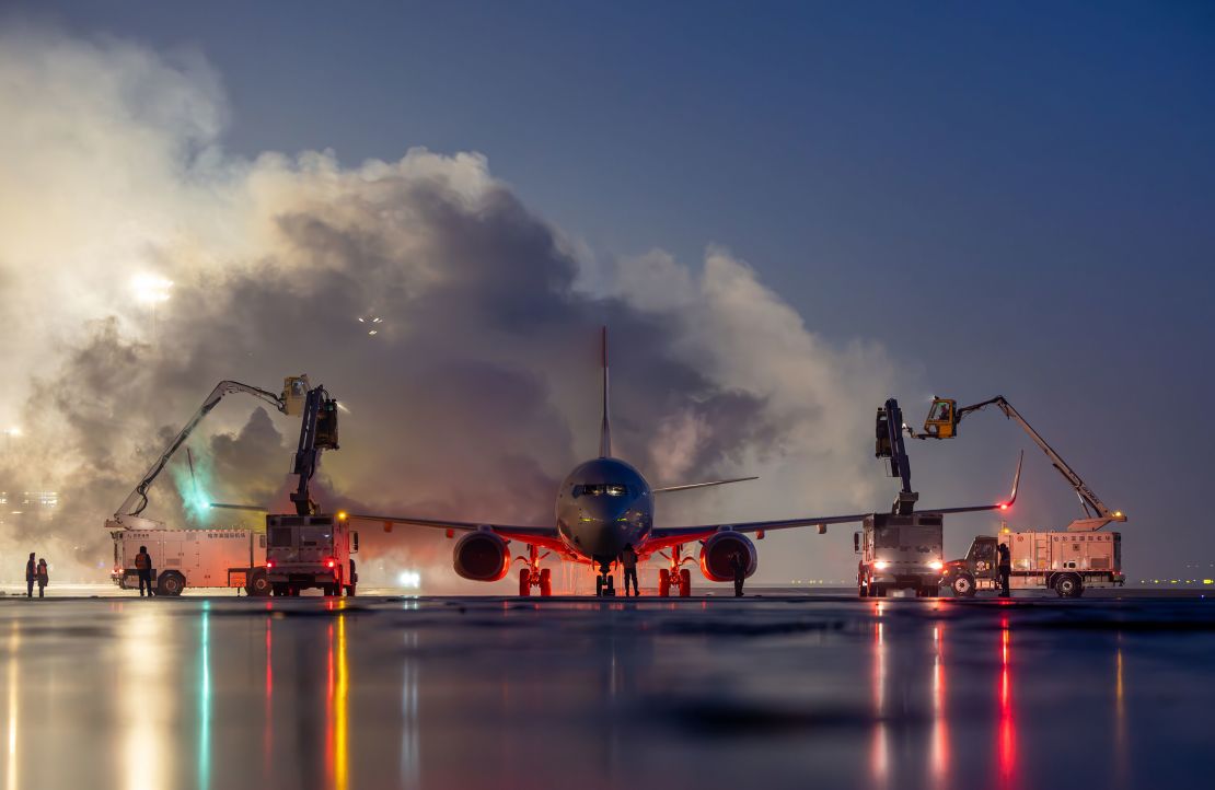 A plane gets the deicing treatment in January 2025 in Harbin, China, famous for its International Snow and Ice Festival.