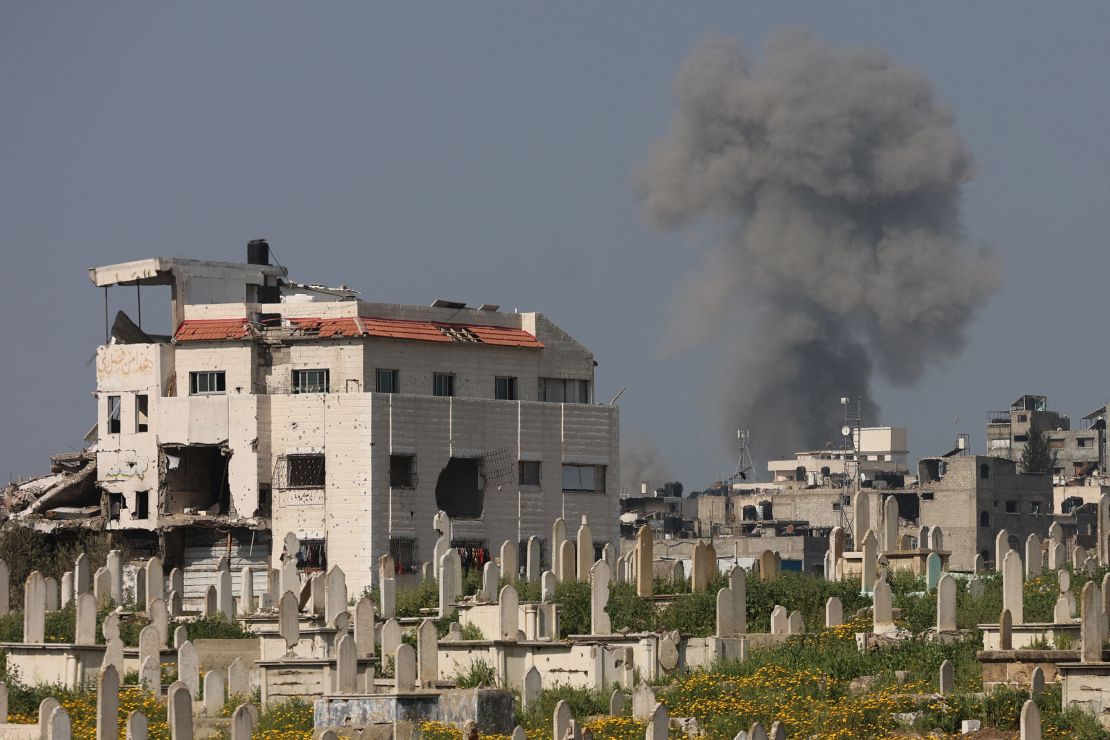 Smoke billows behind a cemetery during Israeli strikes west of Gaza City on Tuesday.