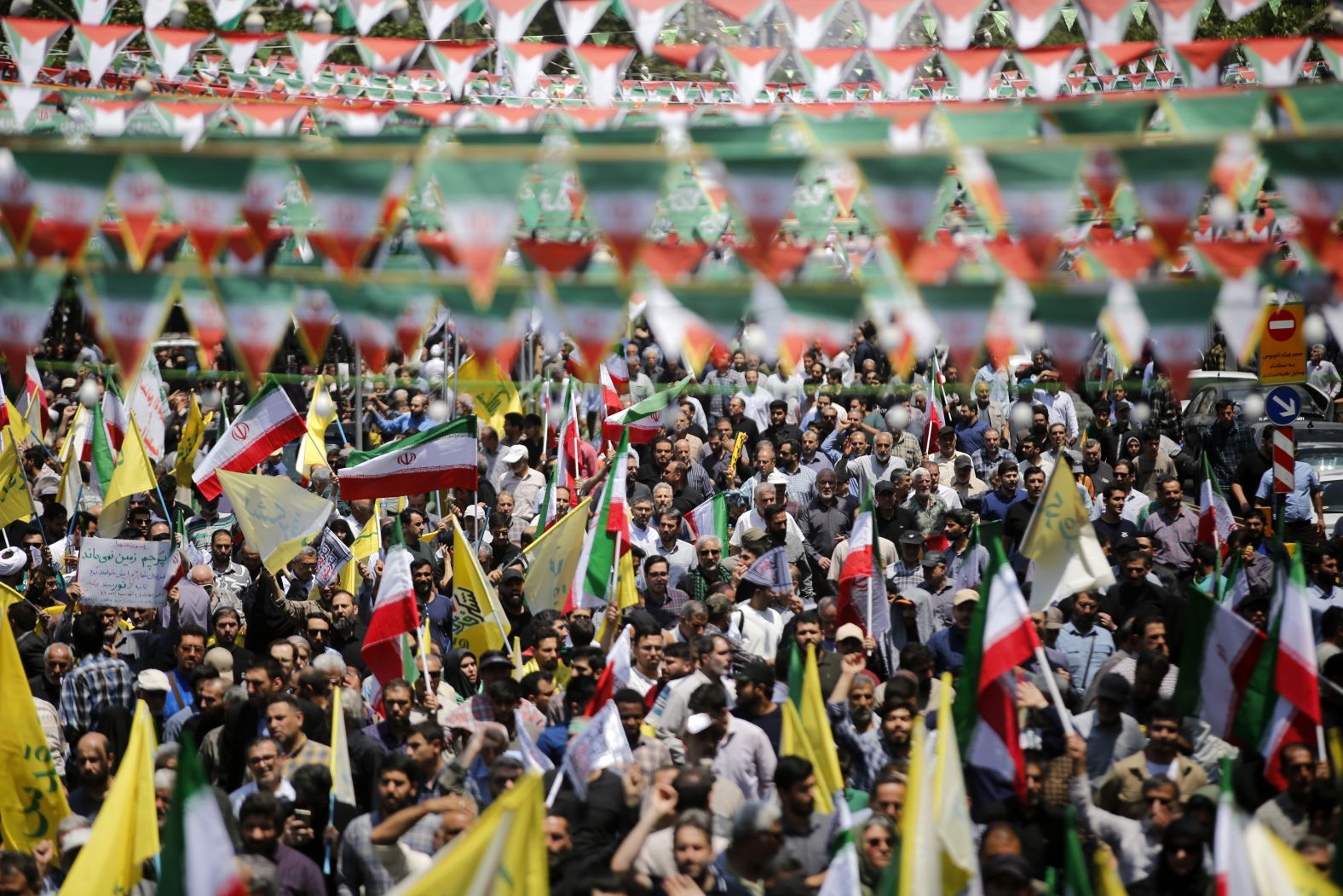 Thousands gather in Tehran's Enqelab Square to protest Israel's attack.