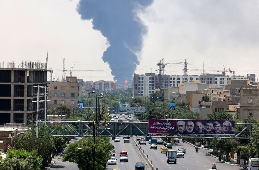 A plume of heavy smoke and fire rise from an oil refinery in southern Tehran, after it was hit in an overnight Israeli strike, on June 15, 2025.