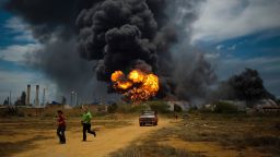 Fuel storage tanks continue to burn after a blast on Saturday at the Amuay refinery in Punto Fijo, Venezuela, Aug. 27, 2012. The accident early Saturday morning killed at least 41 people. (Meridith Kohut/The New York Times)
