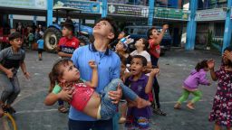 Children look up to the sky at the sound of airstrikes in Gaza City on Monday, Oct. 7, 2023. Residents and health authorities say that mosques, hospitals and schools are being targeted by airstrikes. (Samar Abu Elouf/The New York Times)