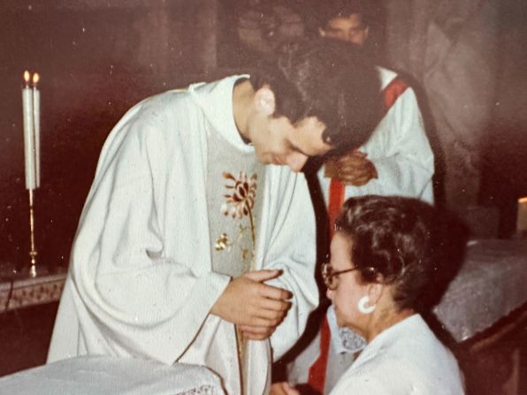 Leo blesses his mother after being ordained as a priest.