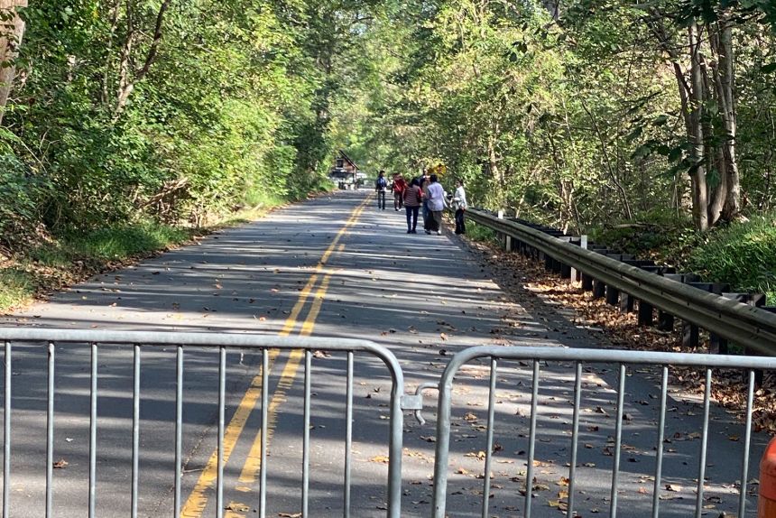 Visitors walking toward the entrance of Great Falls Park after moving past barricades on foot on Friday.