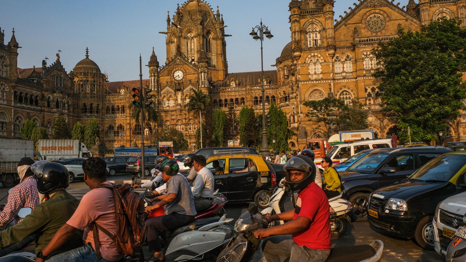 Commuters drive past the Chhatrapati Shivaji Terminus in Mumbai, India, on April 18, 2024.
