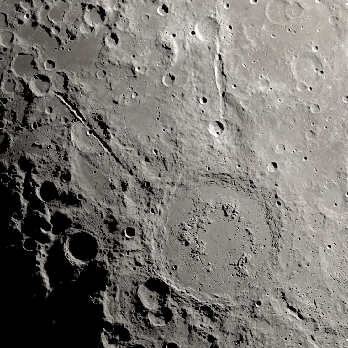 The debris of the impact that created the Schrödinger basin have formed deep canyons that can be seen in streaming far from the crater of this orbative image of lunar recognition.