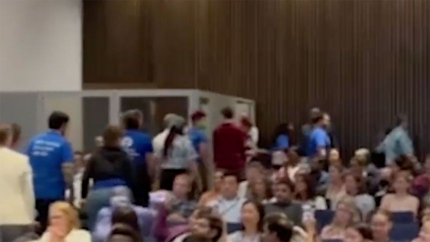 A still from a video obtained by CNN shows NIH staffers leaving the auditorium during a town hall with US National Institutes of Health Director Dr. Jay Bhattacharya.