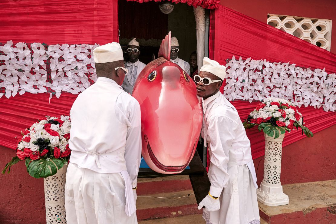 Aidoo’s company, Nana Otafrija (pictured), carries out multiple duties on the day of the funeral and the night before. This funeral, in Greater Accra in 2024, was for a fishmonger. The tail of the fish coffin was too long for the grave, said Tschumi, and had to be sawn off.