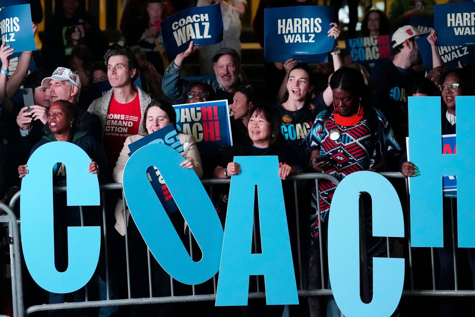 Walz supporters, outside the debate site, show their support for the Democratic candidate, who was a former high school teacher and football coach.