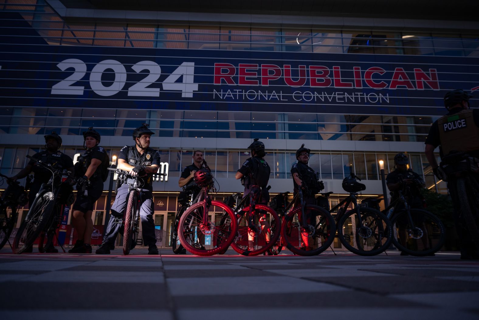 Police officers sit on bicycles in front of the Fiserv Forum on Sunday.