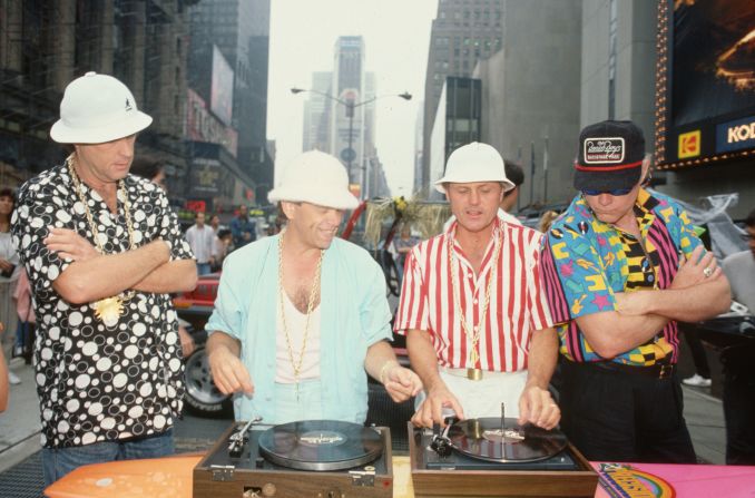 Wilson, left, watches Jardine and Carl Wilson spin records in New York's Times Square in 1987. Love is on the right.