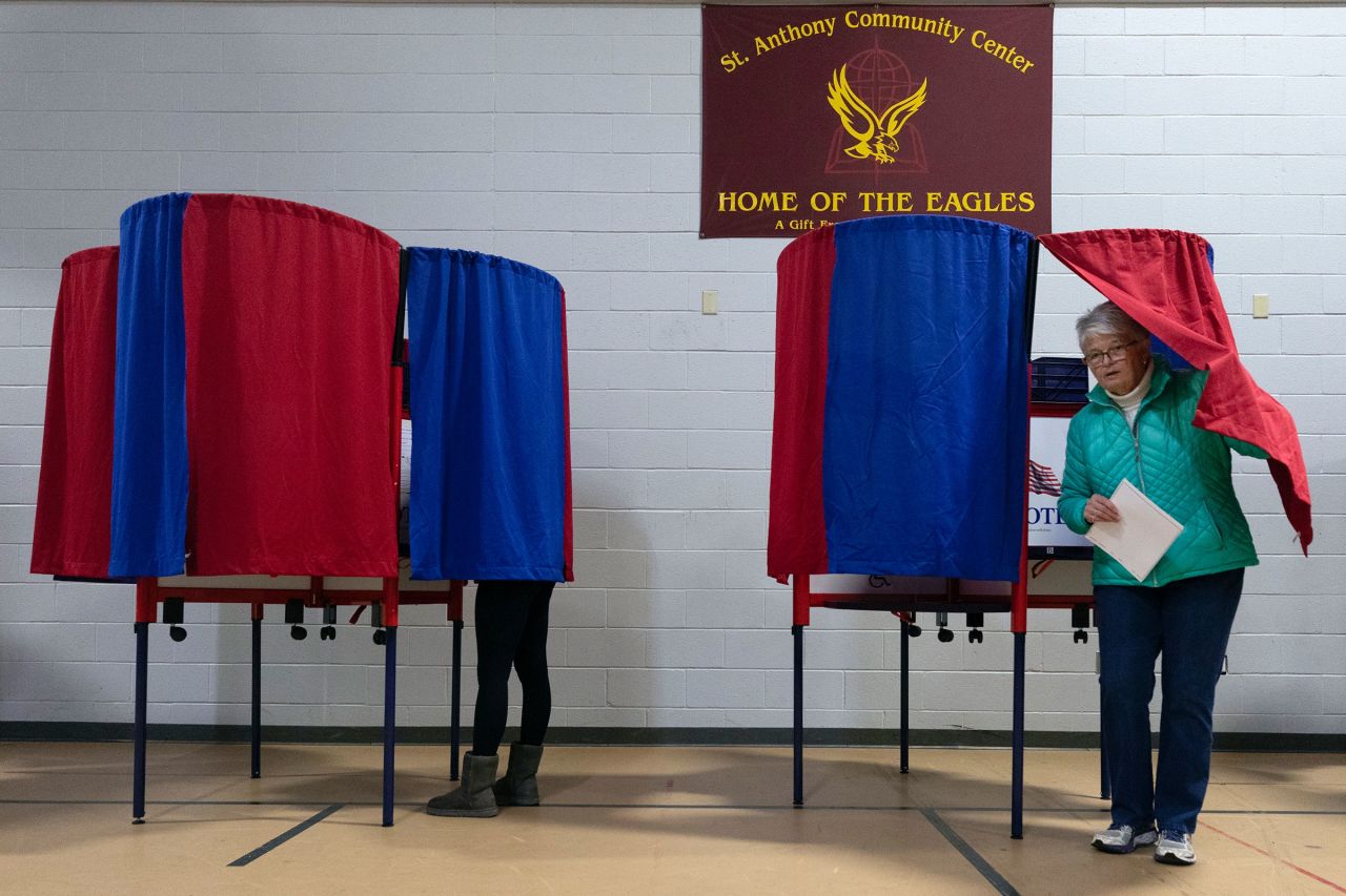 A voter leaves a polling booth at St. Anthony Community Center during the presidential primary election on Tuesday in Manchester.