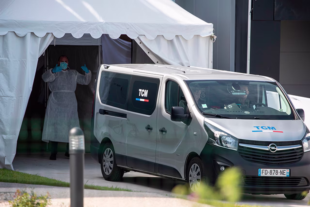 A funeral services van brings coffins in a building turned into a new 'large capacity' morgue in Wissous, France, on Sunday, April 19.