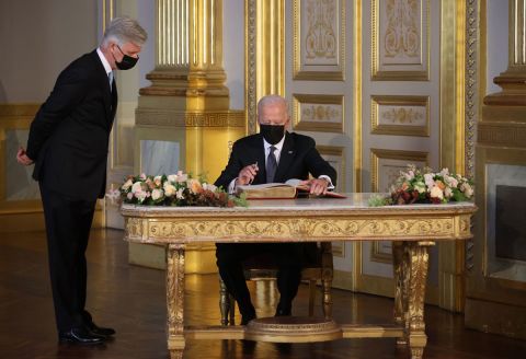 US President Joe Biden signs a book during his meeting with King Philippe at the Royal Palace of Brussels on June 15.