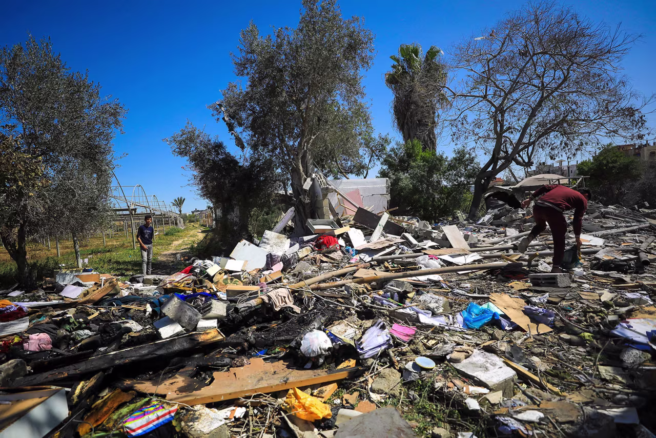 Palestinians inspect the debris of a houses destroyed by Israeli bombardment in Rafah, Gaza on Monday, March 11. 