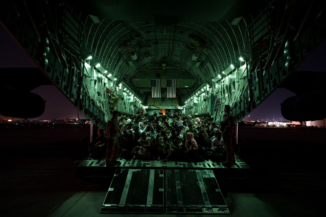 In this handout provided by the U.S. Air Force, an air crew assigned to the 816th Expeditionary Airlift Squadron assists evacuees aboard a C-17 Globemaster III aircraft in support of the Afghanistan evacuation at Hamid Karzai International Airport on August 21 in Kabul, Afghanistan.?